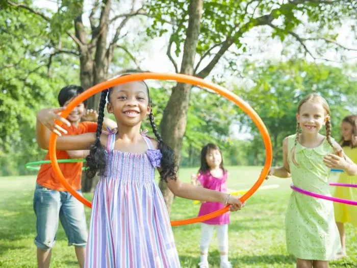 Children playing with hula hoops outdoors