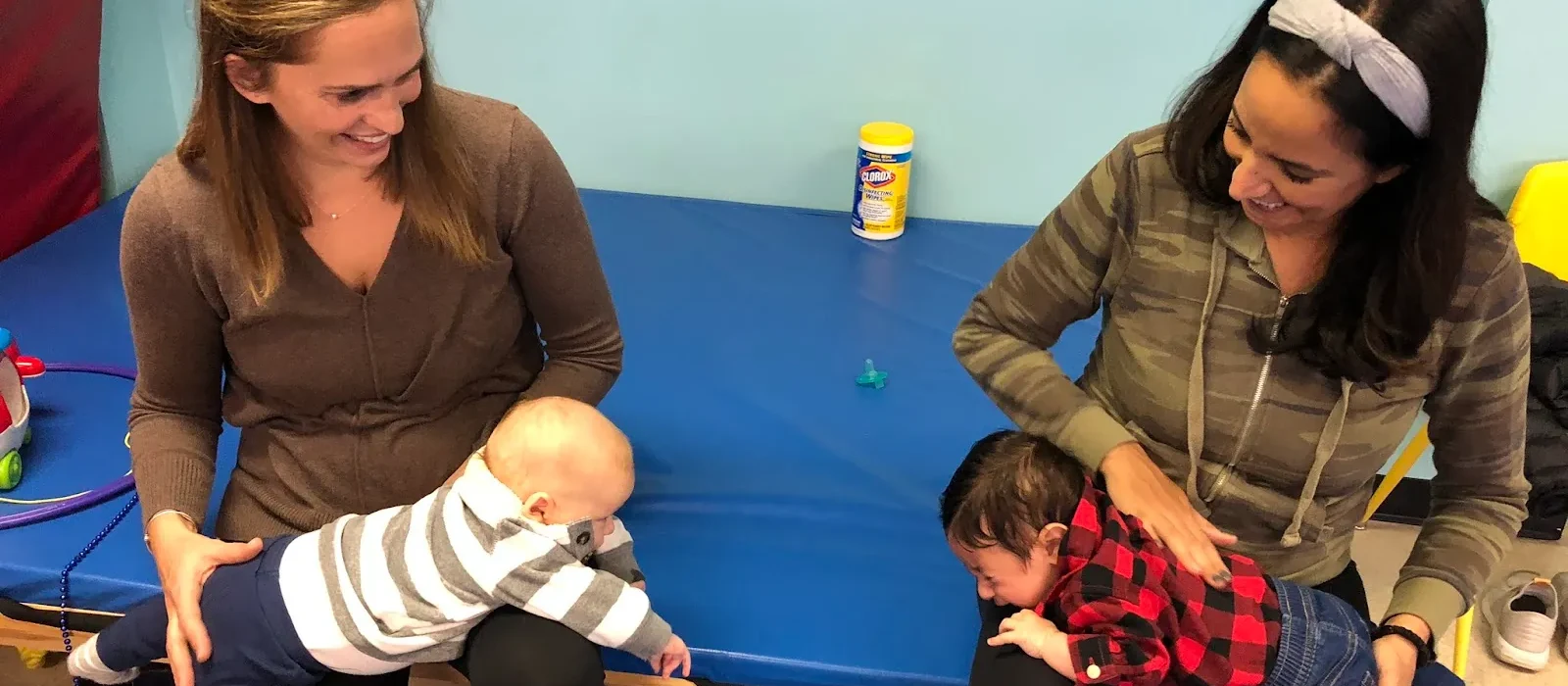 Children playing and climbing in the open therapy gym at Developmental Steps