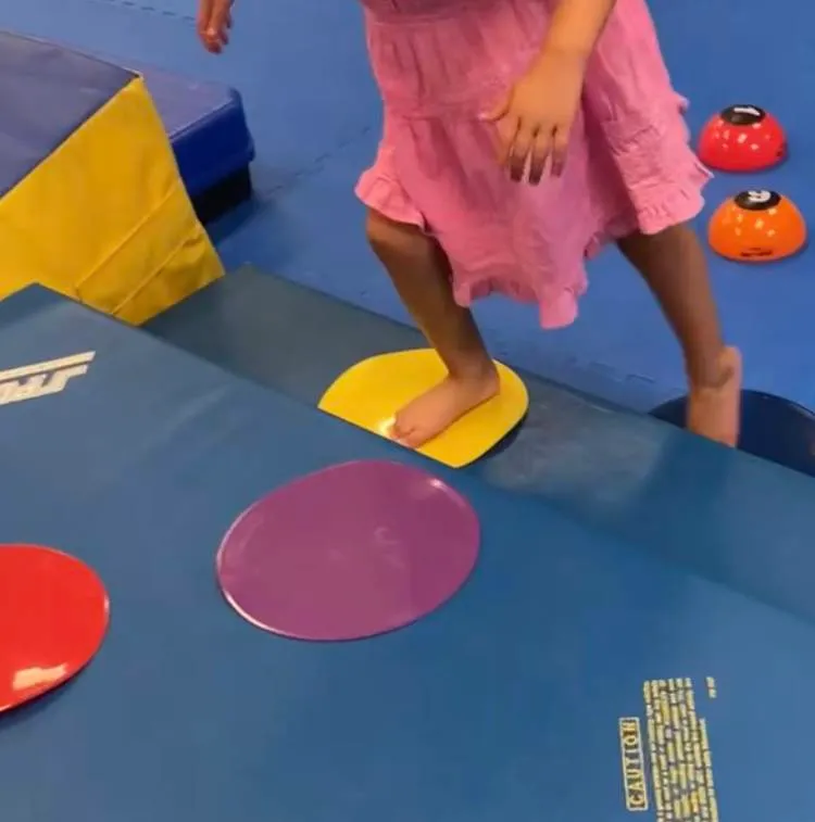 Girl walking on targets in bare feet.